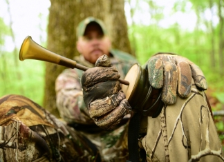 A hunter in West Virginia uses a turkey call to attract a spring gobbler.