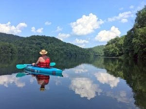 Kayakers glide across the lake at Plum Orchard Lake Wildlife Management Area.