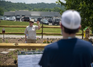 Rachel Rosenberg, a partner biologist with W.Va. Division of Natural Resources and Natural Resources Conservation Service, demonstrates planting techniques.