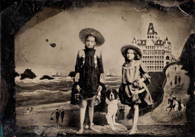 Two young girls pose for a vintage tintype portrait.