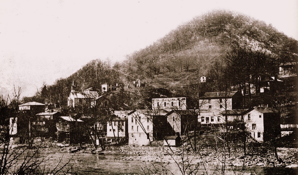 Conley Hill rises beyond the mouth of the New River at Gauley Bridge, West Virginia.