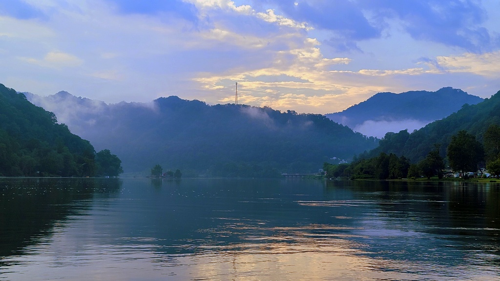 Conley Hill rises beyond the mouth of the New River at Gauley Bridge, West Virginia.