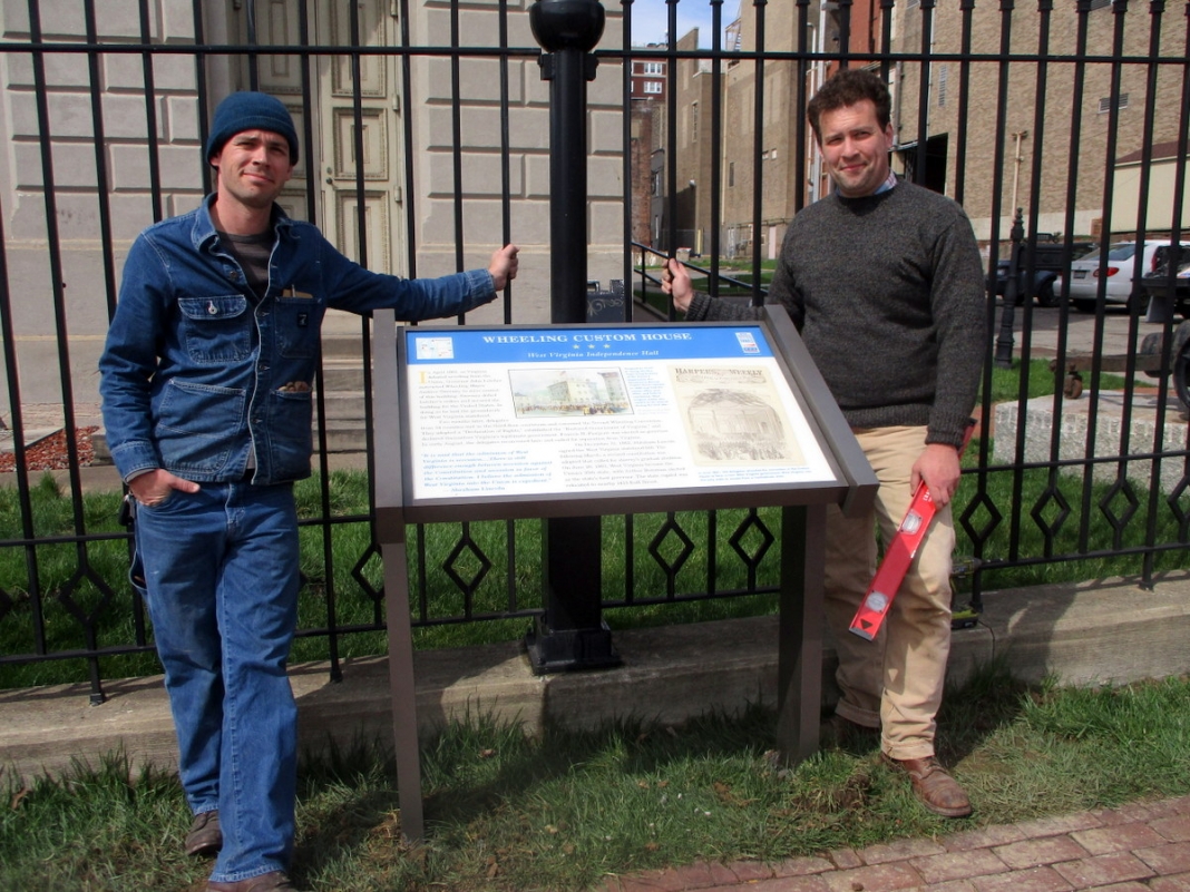 Chris Brown (left) and Drew Gruber (right) pose with the completed sign at Independence Hall.