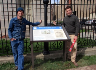 Chris Brown (left) and Drew Gruber (right) pose with the completed sign at Independence Hall.