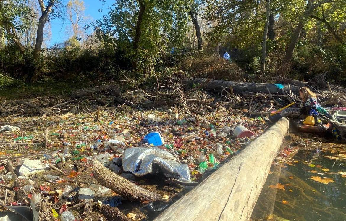 Kayakers face a deluge of litter on streams where water recreation is becoming increasingly vital. (Photo Members of the Trash-Your-Kayak Cleanup Crew paddle at a launch on a West Virginia stream. 