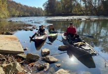 Members of the Trash-Your-Kayak Cleanup Crew paddle at a launch on a West Virginia stream.
