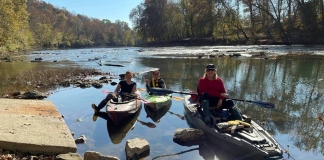 Members of the Trash-Your-Kayak Cleanup Crew paddle at a launch on a West Virginia stream.