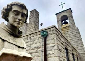 A statue of Saint Anthony of Padua stands outside Saint Anthony's Shrine at Boomer, West Virginia .