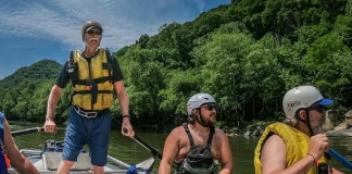 Paul Breuer guides a whitewater raft through the New River Gorge