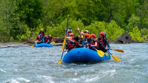 Whitewater rafters and kayakers paddle the Shenandoah River. 
