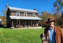 David Sibray holds an antique lantern at the Covey House