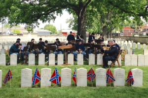 A Union Regimental Band plays under the shade of a mature Sweet Gum tree in the Camp Chase Confederate Cemetery.