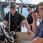 A West Virginia Division of Natural Resources police officer talks with a recreational boater during a routine safety check. Officers across the state increase boating safety patrols during the busy Fourth of July holiday, reminding visitors that alcohol and drugs can impair judgment, balance and reaction time on the water.