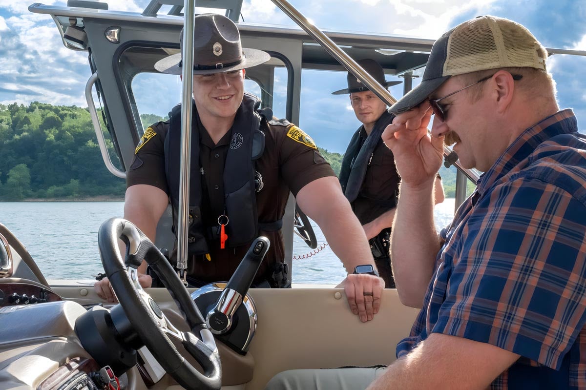 A West Virginia Division of Natural Resources police officer talks with a recreational boater during a routine safety check. Officers across the state increase boating safety patrols during the busy Fourth of July holiday, reminding visitors that alcohol and drugs can impair judgment, balance and reaction time on the water.
