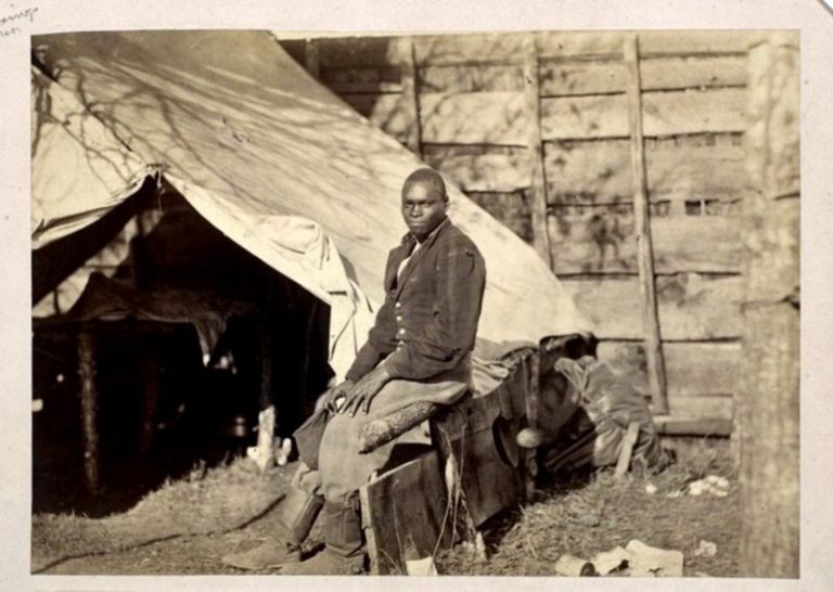 A photograph taken about 1862 of a "contraband servant" named John Henry in a Union Army Camp.