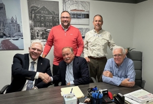 Representatives of the Buckskin Council and the Camp Kootaga Foundation close on the sale.