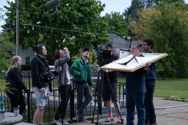 Directors gauge lighting while filming a scene from the comedy "Ambrosia!"