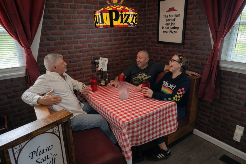 Appalachian Escapes: Straight out of the ’80s: David Sibray, Nate Adams, and Rachel Adkins swap stories in a replica Pizza Hut. (Photo: Holly K. Clark)