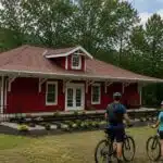 Tourists on bicycles visit the Elk River Trail Visitor Center.