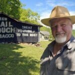 Inspired by historian Cody Straley, publisher David Sibray visits a small Mail Pouch barn on US-119 off the Elk River near Blue Creek.