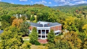The portico of teh Pence Springs Hotel looks out across the scenic valley of the Greenbrier River. 