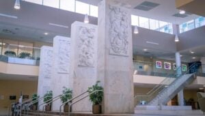 Four marble pylons at the WVU Health Sciences Center depict the history of the healing arts, including medicine, nursing, dentistry, and pharmacy.
