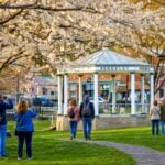 Visitors gather around the historic bandstand in Berkeley Springs State Park, where many first-time travelers discover that the town's official name is actually Bath, a distinction that has endured since 1776. (WVExplorer photo)