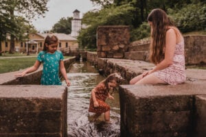 Three children play in the shallow mineral-water pool at Berkeley Springs State Park. The warm springs, which flow year-round at about 69.8 degrees, have drawn visitors to the town since colonial times. (Photo: Travel Berkeley Springs)