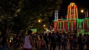 Festivalgoers fill Kanawha Boulevard after dark as carnival rides illuminate the Charleston Sternwheel Regatta, part of West Virginia's America250 Capital City Celebration during the Independence Day weekend.