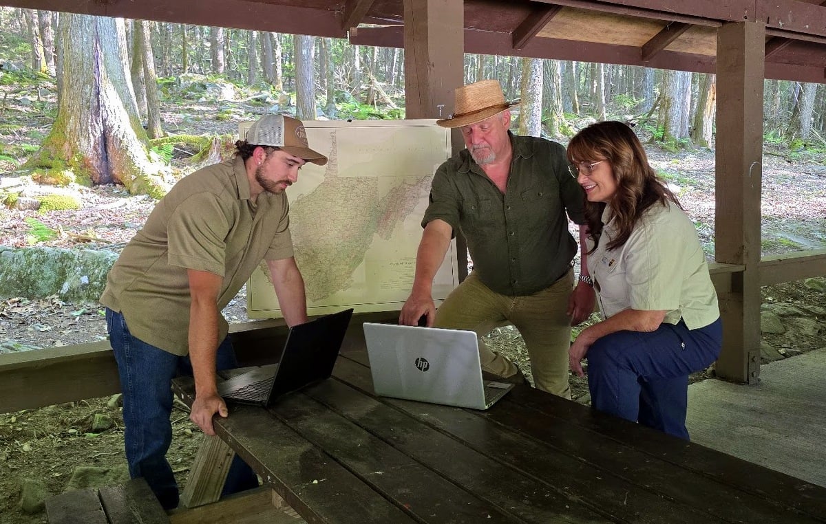Davie Chinn, David Sibray, and Lori Noble meet at Little Beaver State Park to discuss increased promotion of outdoor recreation.