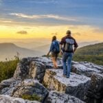 A young couple hikes to an overlook in the Dolly Sods Wilderness, where elevations above 4,000 feet and expansive mountain vistas make the high country a refreshing escape during the Fourth of July holiday. (Photo: WV Tourism)