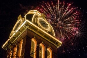 Fireworks illuminate the sky behind Woodburn Hall at West Virginia University. Medical experts say hand injuries, burns, and other fireworks-related accidents increase sharply around the Fourth of July holiday. (Photo illustration: WVExplorer)