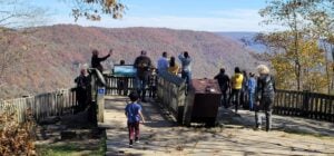 Visitors gather at the Main Overlook at Grandview, just steps from the historic Cliffside Amphitheatre, where the annual Sounds of Appalachia program celebrates the music, stories, and traditions of the New River Gorge region. The scenic overlook is among the most visited destinations in New River Gorge National Park and Preserve and introduces many visitors to the cultural landscape that has inspired generations of Appalachian musicians and storytellers. (Photo by David Sibray / West Virginia Explorer)