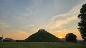 The sun sets beyond the Grave Creek Mound as seen from the old W.Va. State Penitentiary.
