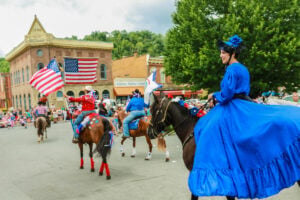 Participants in period costumes ride through Alderson during the town's annual Fourth of July parade, a hallmark of one of West Virginia's oldest and most celebrated Independence Day traditions.