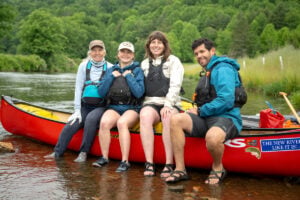Members of the New River Expedition crew gather at the start of a 320-mile paddle journey documenting the New River from North Carolina to West Virginia. From left are Ann Rose, Anastasia Jeffcoat, Lucy Bolin, and David Bernier. (Photo courtesy New River Conservancy)