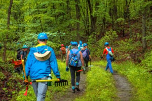 Volunteers carry trail building tools to the staging area on Peters Mountain.