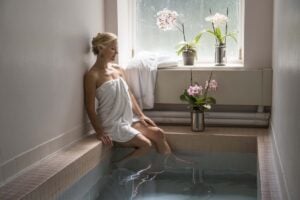 A visitor relaxes during a spa treatment at Berkeley Springs State Park, where mineral-water baths continue a wellness tradition that began more than two centuries ago. The warm springs inspired the founding of the Town of Bath in 1776 and remain the heart of the community today. (Photo: Travel Berkeley Springs)