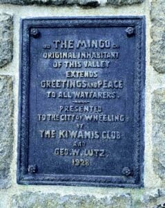The plaque on the base of Wheeling's Mingo Statue explains the monument's dedication to the Native peoples who lived in the Ohio Valley before European settlement. The statue has overlooked the city from Wheeling Hill since 1928.