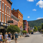 Visitors explore the historic downtown of Hinton, a gateway to the southern reaches of New River Gorge National Park and Preserve, where brick-lined streets, local shops, and mountain scenery offer a quieter side of the park experience. (Photo: David Sibray / WVExplorer)