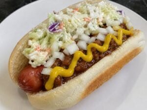 A West Virginia hot dog topped with mustard, chili, onions, and coleslaw. The chili-slaw dog remains one of the state's most enduring food traditions.
