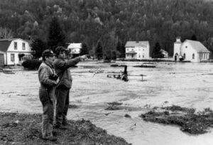 Residents look over floodwaters engulfing a West Virginia community during the Great Flood of November 1985. Torrential rains sent rivers and creeks out of their banks across much of the state, killing 47 people and causing hundreds of millions of dollars in damage. (Photo by John Warner)