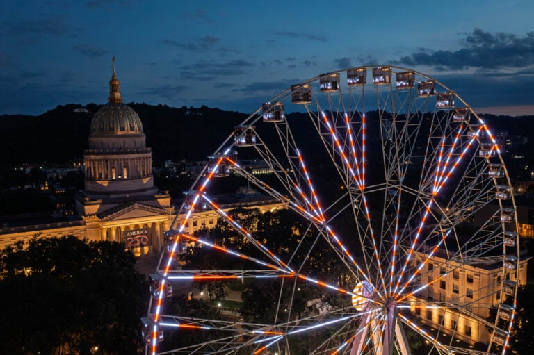 The 230-foot America250 Wheel, billed as the world's tallest portable Ferris wheel, towers above the West Virginia State Capitol during preparations for the state's America250 Capital City Celebration in Charleston. (Photo: W.Va. Tourism)