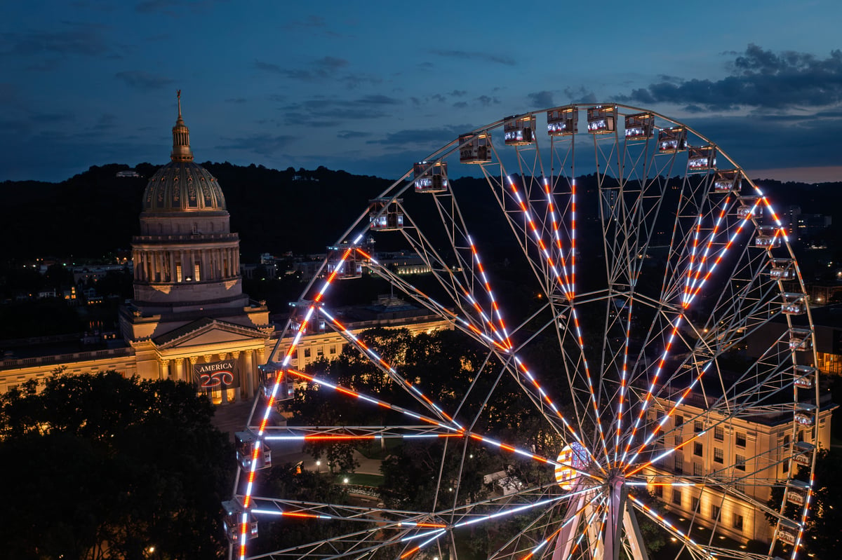 The 230-foot America250 Wheel, billed as the world's tallest portable Ferris wheel, towers above the West Virginia State Capitol during preparations for the state's America250 Capital City Celebration in Charleston. (Photo: W.Va. Tourism)