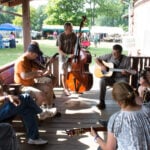 Musicians gather in an informal jam session beneath the trees at the Appalachian String Band Music Festival near Clifftop, W.Va. Unlike most music festivals, the heart of the event is found in hundreds of spontaneous circles where participants play together, preserving the traditions of old-time Appalachian music.
