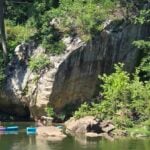 Kayakers paddle around Big Rock on the lower Greenbrier River near Hinton, West Virginia.