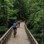 Cyclists cross a bridge on the Clear Fork Rail Trail, one of several recreation projects helping expand outdoor opportunities in Raleigh County.