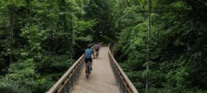 Cyclists cross a bridge on the Clear Fork Rail Trail, one of several recreation projects helping expand outdoor opportunities in Raleigh County.