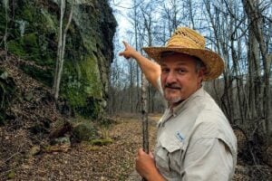 WVExplorer publisher and historian David Sibray points to McKinley Rock, a sandstone cliff along the Rend Trail that has long been associated with one of the New River Gorge's best-known legends. According to local tradition, railroad workers noticed what appeared to be the profile of President William McKinley in the rock shortly before learning he had been shot in 1901.