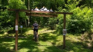 A cyclist rides into the Eleanor Park Trails in Putnam County. Local leaders say expanding trail systems and growing interest in outdoor recreation are helping reshape the county's identity beyond its traditional role as a suburban community between Charleston and Huntington.